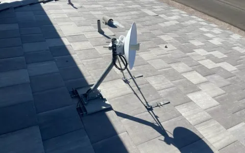 Professional fixed wireless internet dish on a non-penetrating roof mount installed on a Las Vegas home
