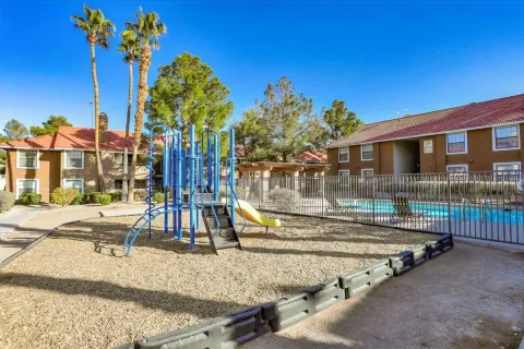 Apartment buildings, playground, and pool at Summerlin Entrada in Las Vegas